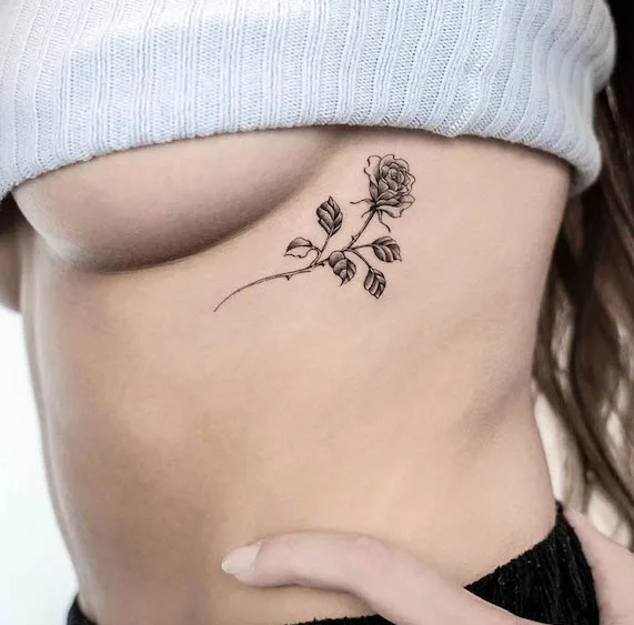 Chloe's rose rib tattoo